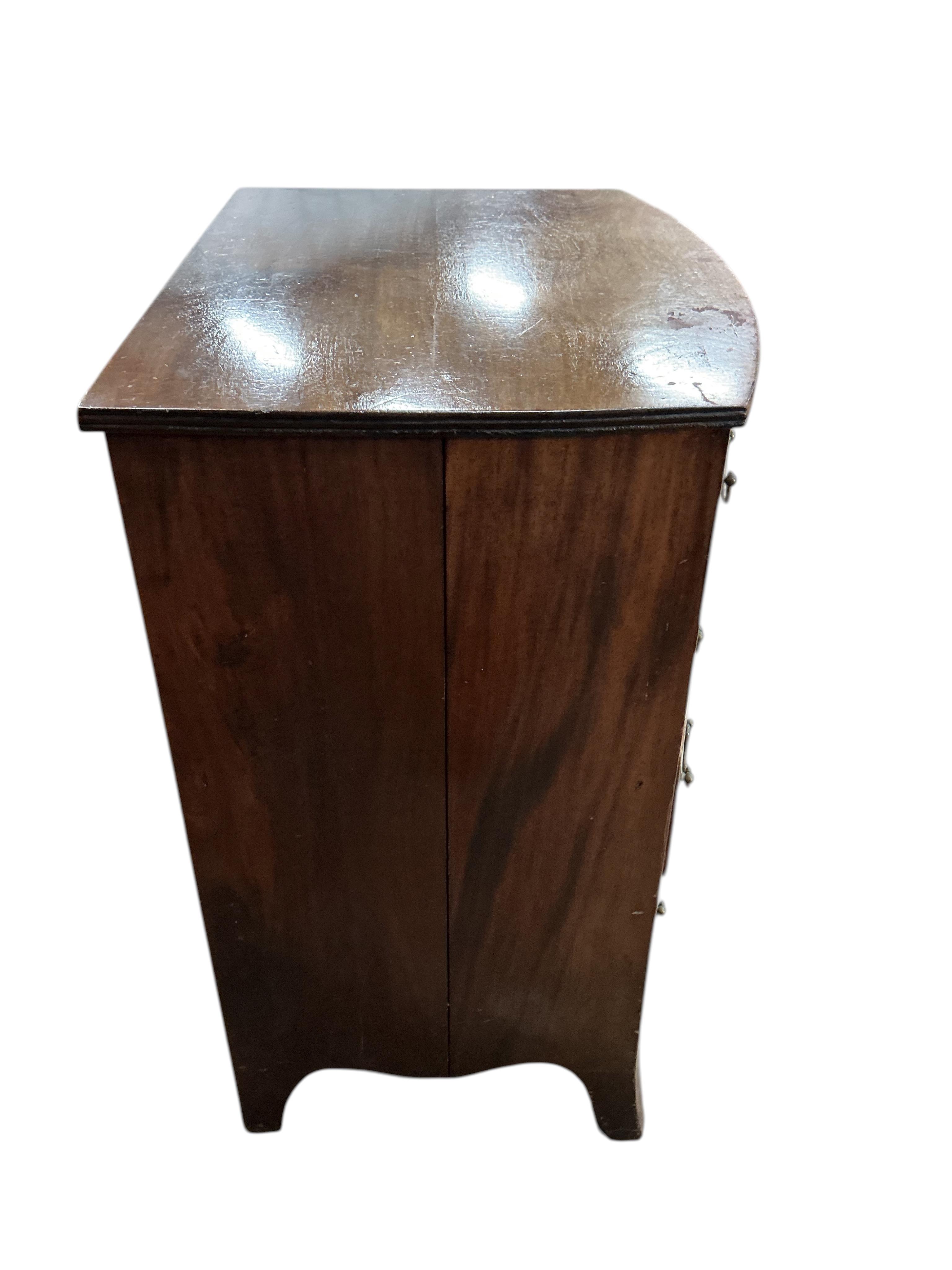 A small Regency style bow front four drawer mahogany chest, width 64cm, depth 48cm, height 84cm